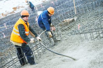 concreting work. Two concreter with vibration tool Coral Gables,